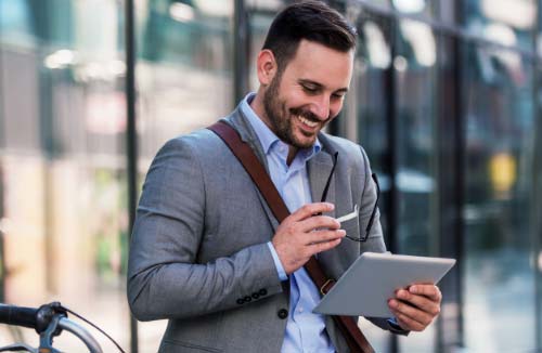 man looking at his personal tablet device