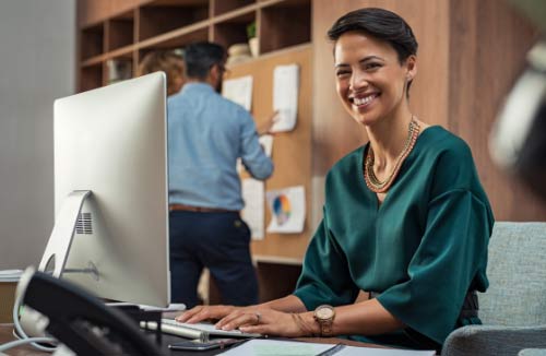 woman smiling at her desk