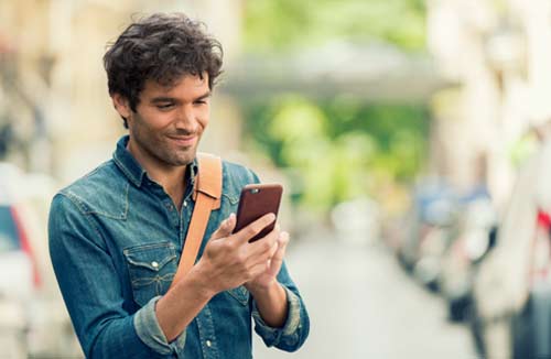 young man looking at his smartphone